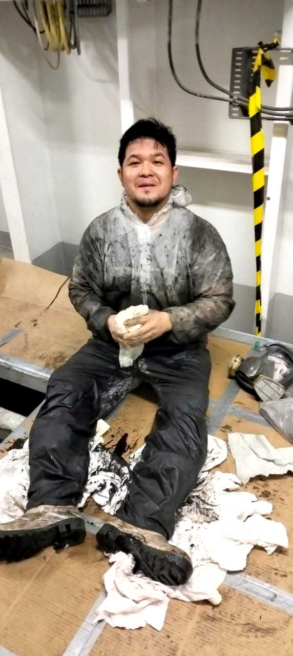 Cadet performing painting maintenance on the ship's exterior